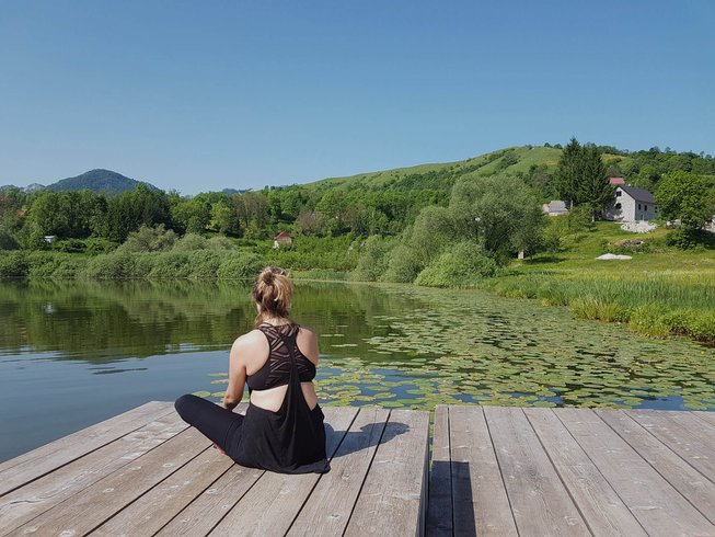 Woman sitting beside lake Best Yoga Retreats in Montenegro