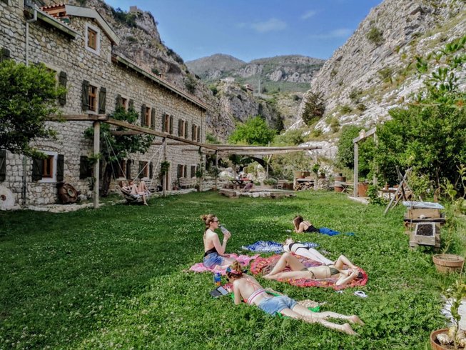 People lying on grass outside Best Yoga Retreats in Montenegror