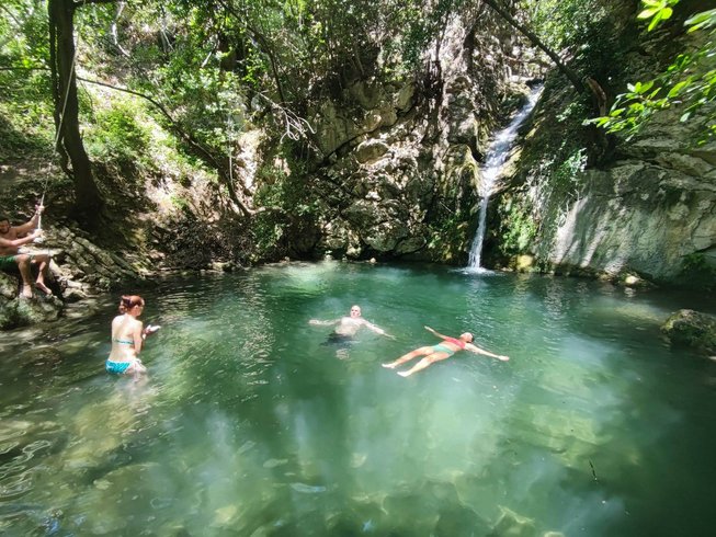 People swimming in secret pool with waterfall Best Yoga Retreats in Montenegro