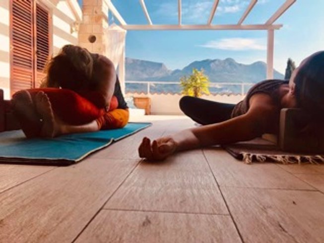 People doing yoga on balcony Best Yoga Retreats in Montenegro
