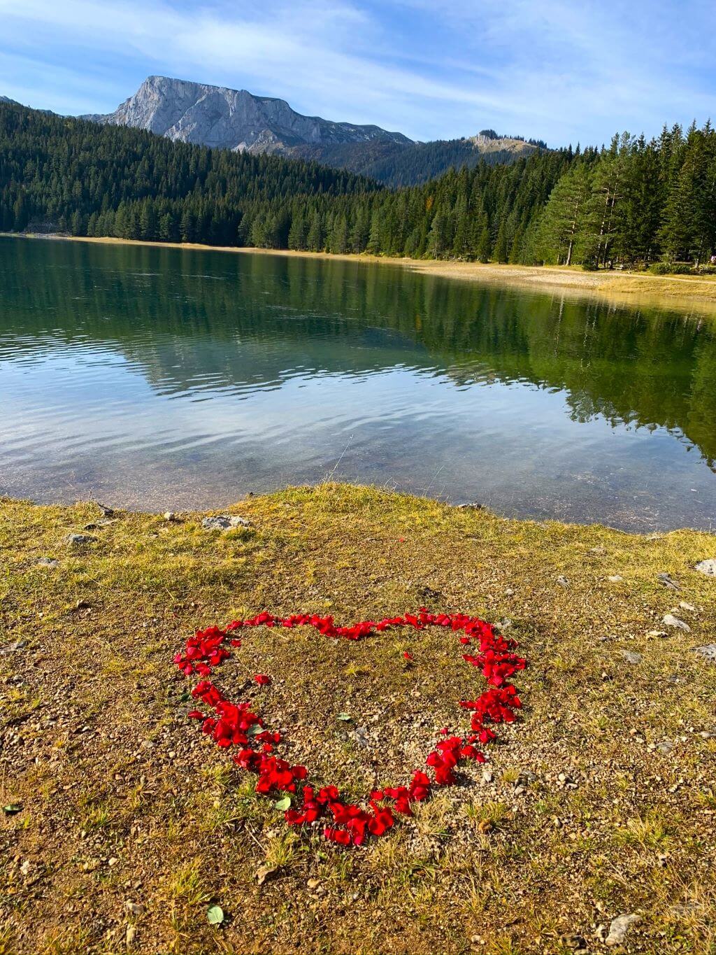 The Black Lake and Medjed Peak Black Lake, Zabljak, Durmitor with heart in rose petals