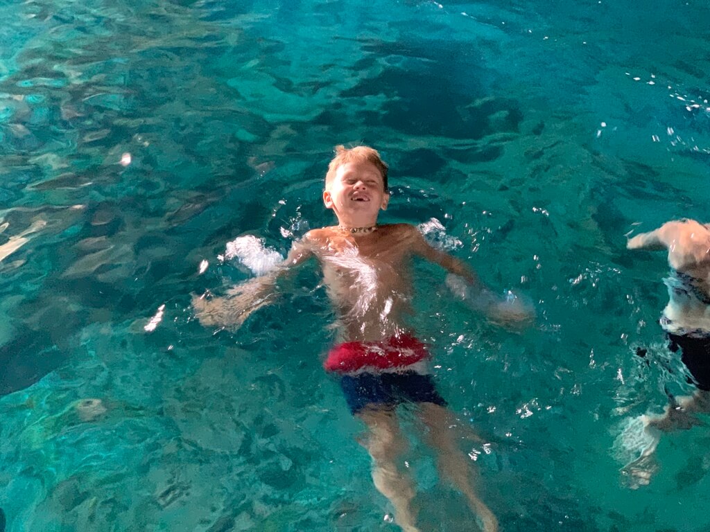 Swimming in the magical Blue Cave – Kotor Bay adventure Child swimming in the glowing blue waters of the Blue Cave near Kotor, Montenegro