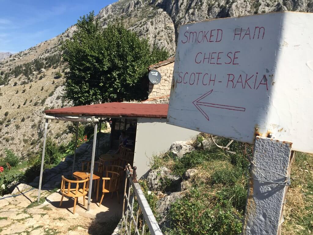 Sign for Spiljari cafe Kotor walls walk up San Giovanni Fortress in Montenegro.