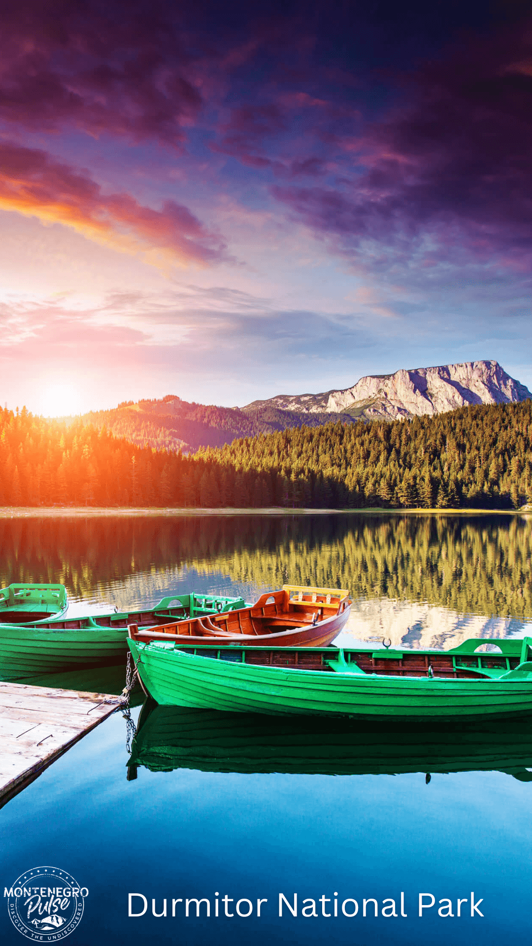 Green boats docked on a serene lake with mountains in the background during sunset in Durmitor National Park, Montenegro.
