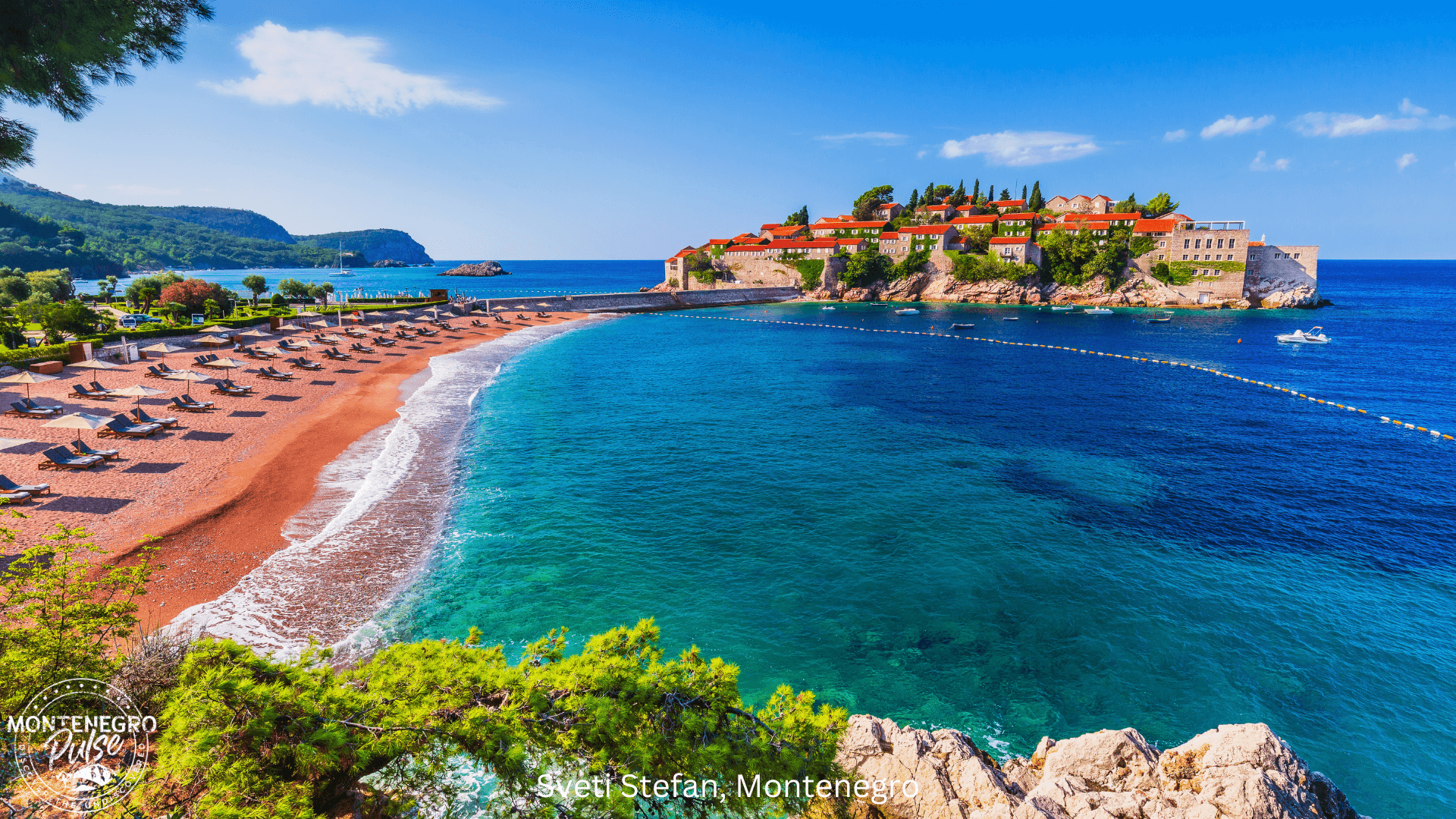 Sunny beach with sunbeds and the iconic island of Sveti Stefan in the distance, Montenegro.