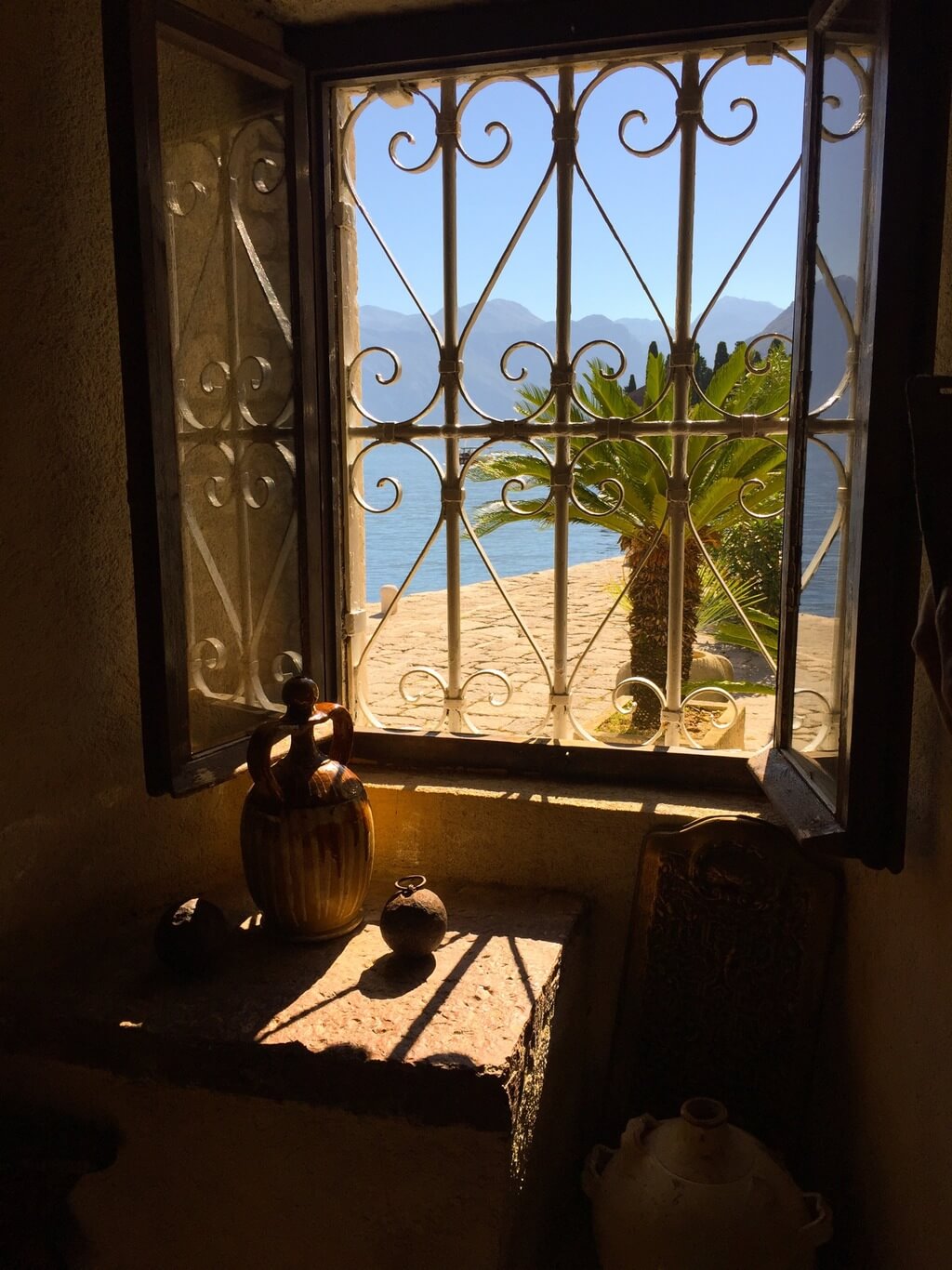 Looking through window The Ultimate Guide to Our Lady of the Rocks in Perast in the Bay of Kotor, Montenegro. Find out how to visit one of Montenegro's top attractions.