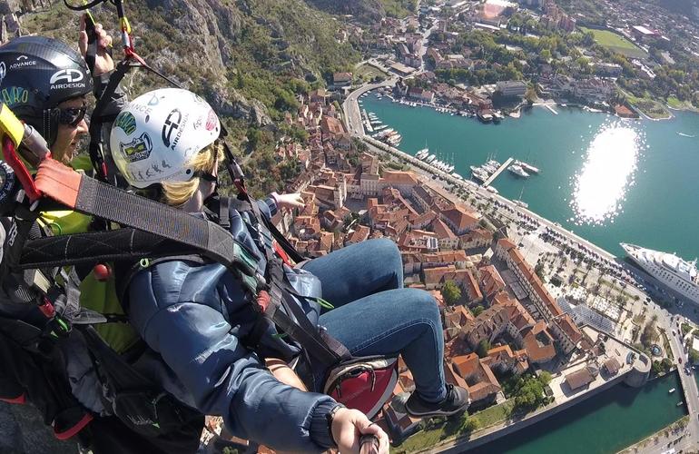 Paragliders soaring over Kotor Old Town and Bay of Kotor with stunning aerial views