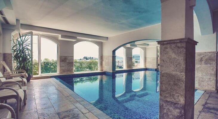 Hotel Azimut pool Sveti Stefan Hotel Azimut has an indoor pool overlooking the hamlet and island of Sveti Stefan, Montenegro.